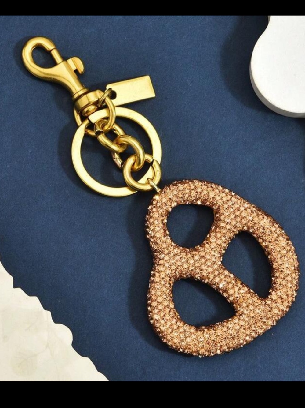 Coach Gold-Tone Crystal Pretzel Key Charm in Rose Gold Crystal